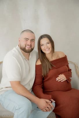 Couple holding hands during Maternity Session
